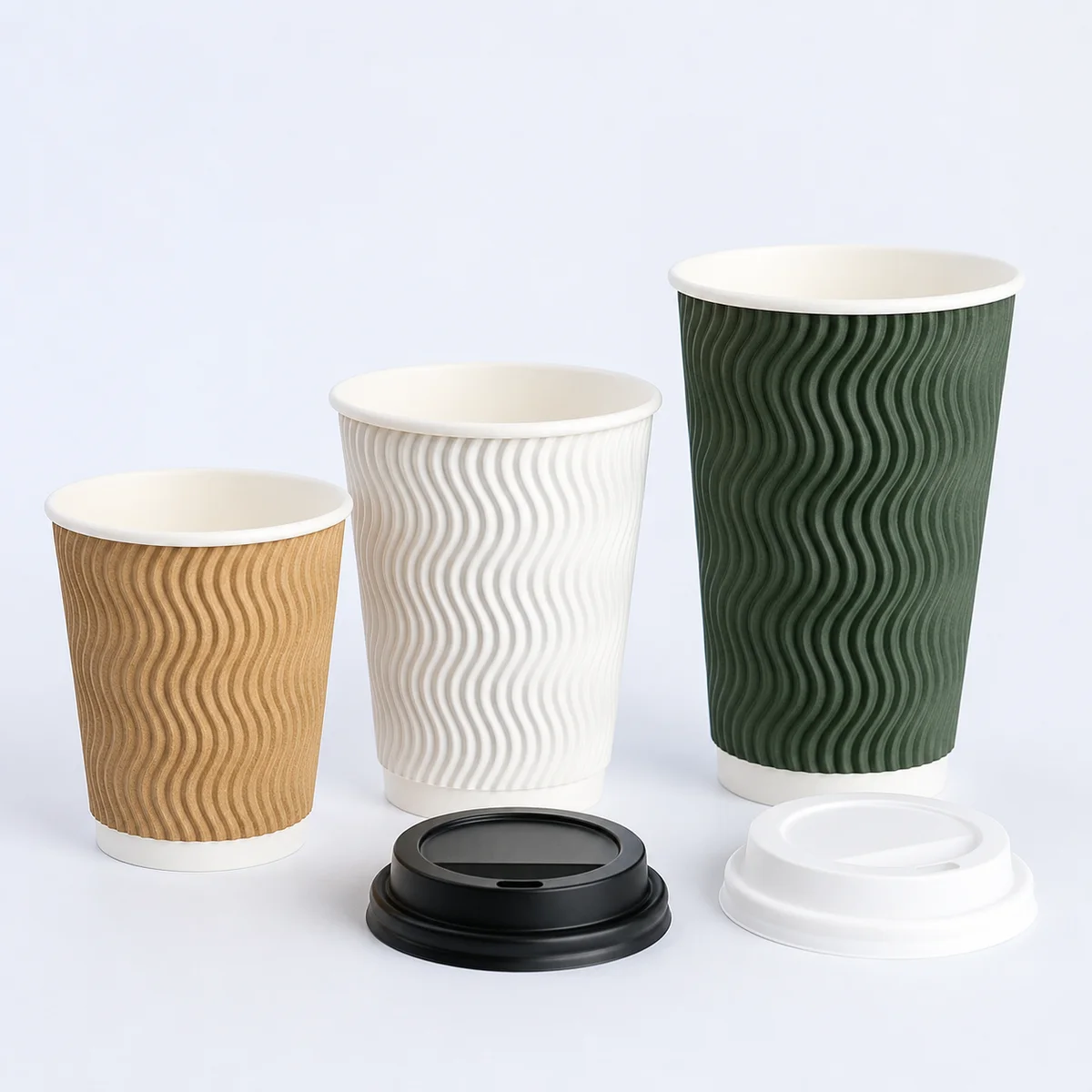 Ripple wall paper coffee cups in kraft white and green with visible wave texture and sip lids